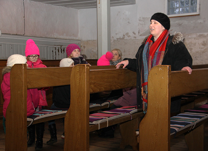Suure-Jaani kultuurimaja käsitööringi naised ja Lahmuse kooli noored kudusid Suure-Jaani kirikule triibulised pingikatted